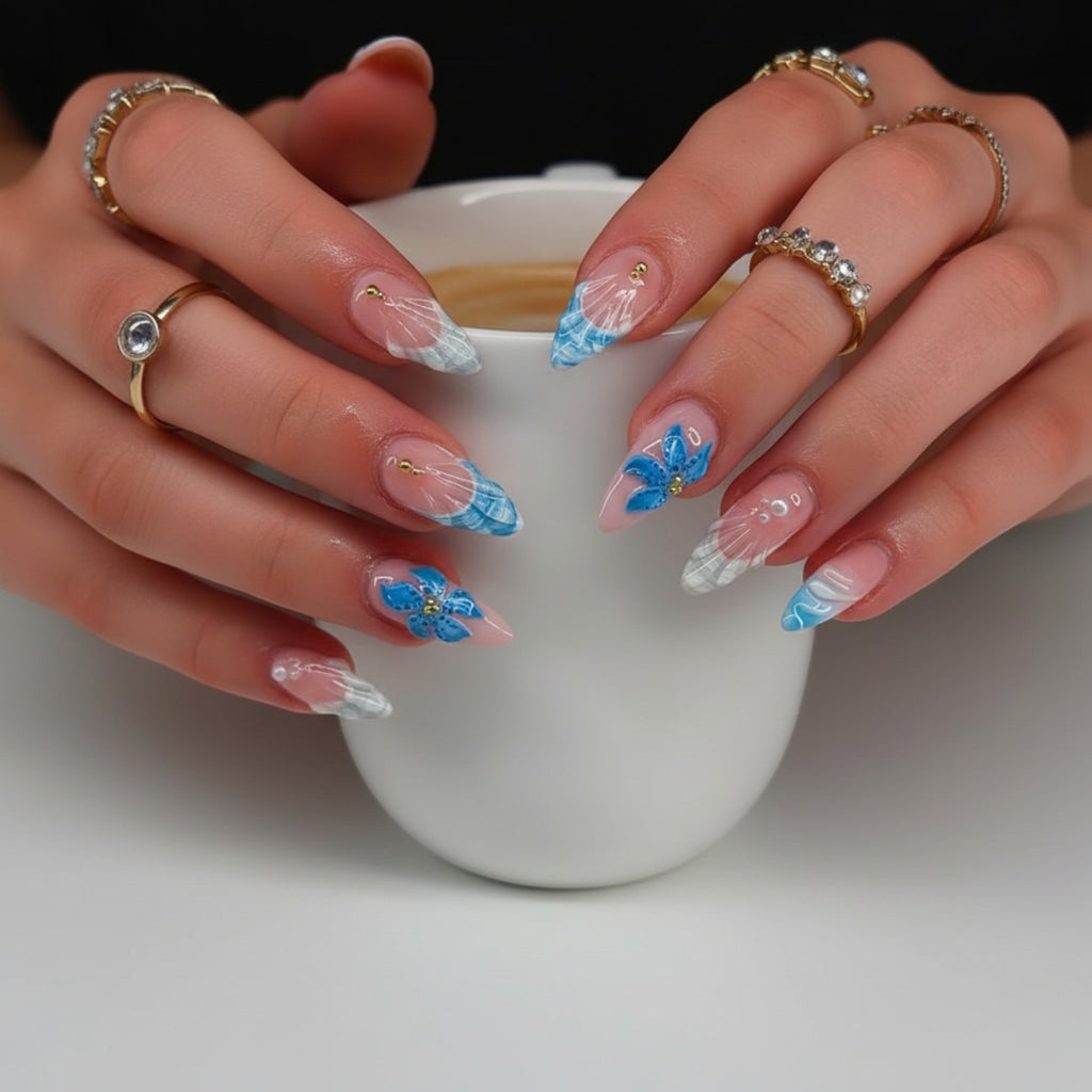 Aura24 press-on nails with blue floral designs and white accents. Almond shape, glossy finish.