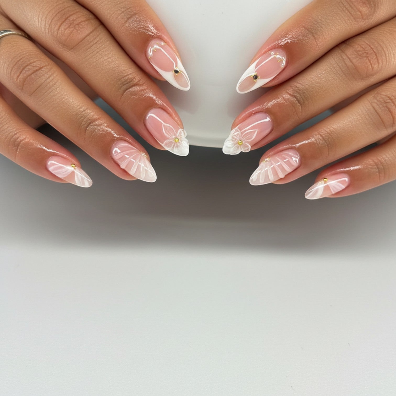 AuraPal French tip press-on nails with 3D white flowers, delicate white swirls, and gold accents.