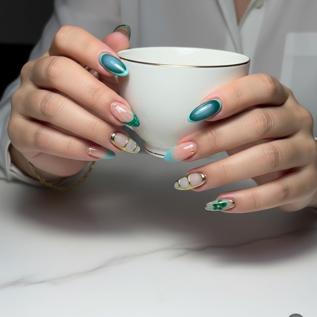 Aurapal Aura32 press-on nails with green and blue French tips, gold accents, and a clover design.