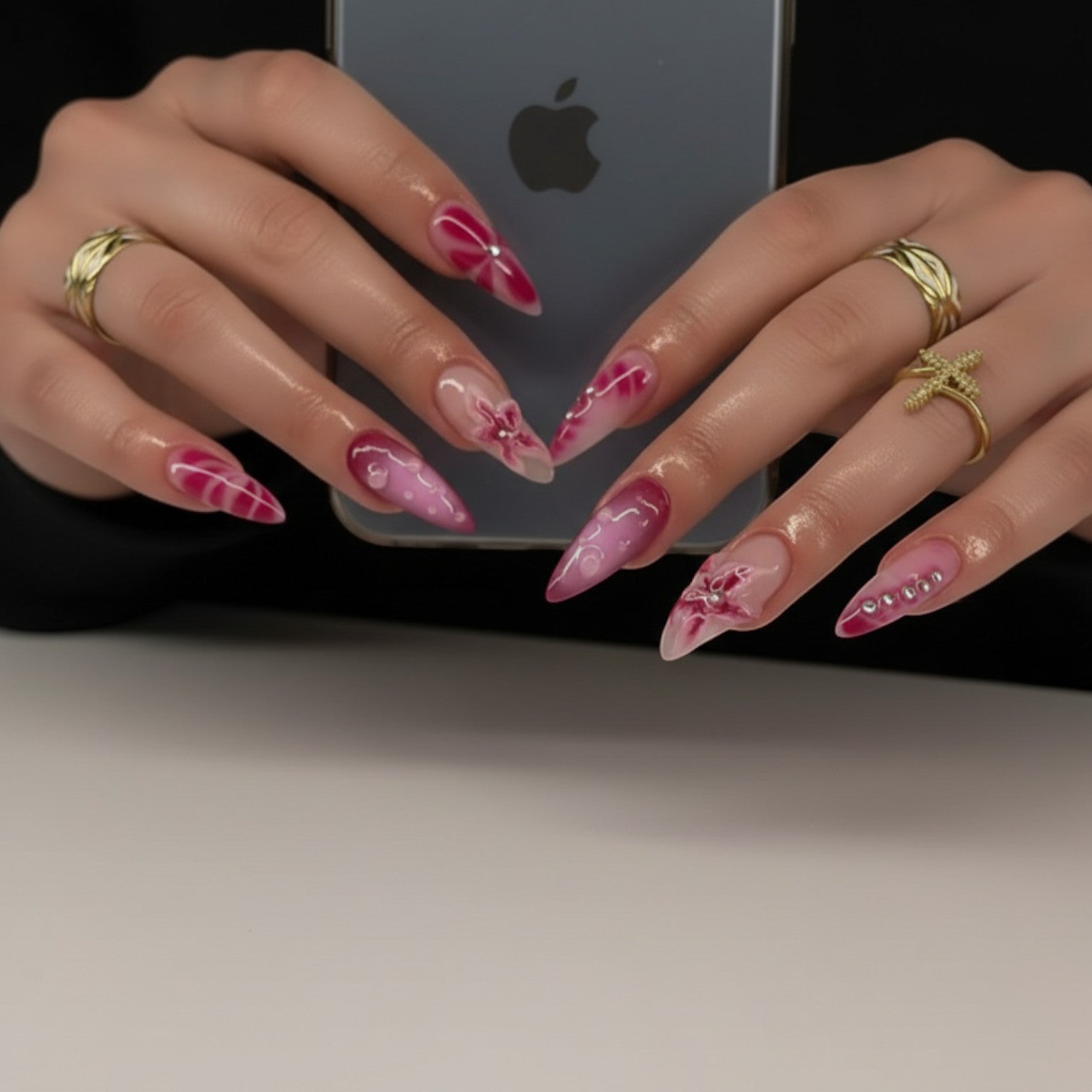 Aurapal Aura40 stiletto press-on nails with pink marble and floral designs, adorned with rhinestones.