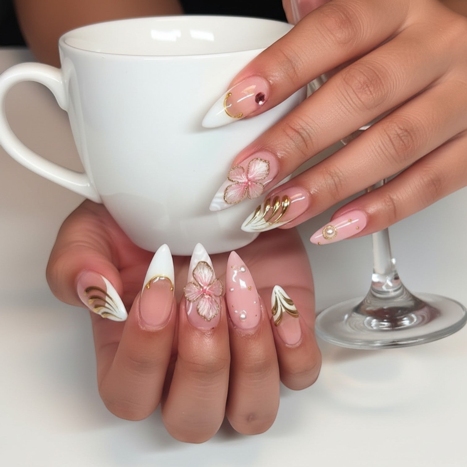 Aurapal Aura41 press-on nails with pink floral 3D accents, pearls, and gold details. Stiletto shape.