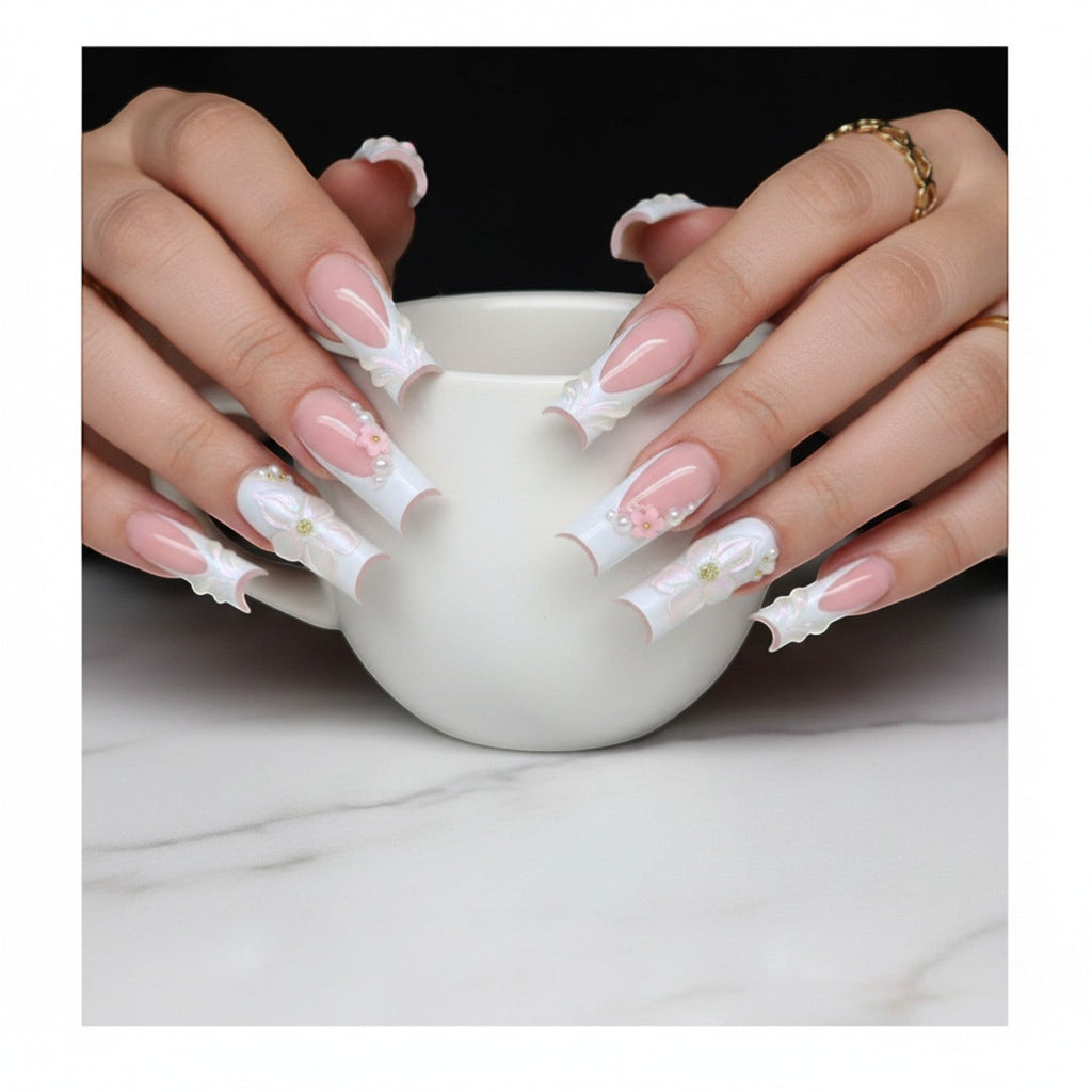Aurapal Aura59 press-on nails with pink French tips, white 3D floral accents, pearls, and gold beads.