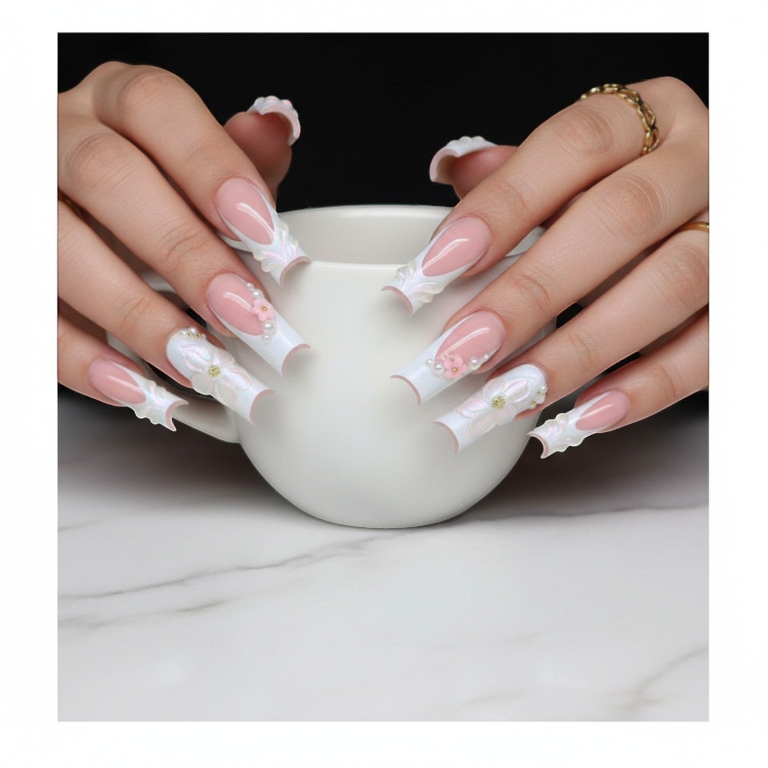 Aurapal Aura59 press-on nails with pink French tips, white 3D floral accents, pearls, and gold beads.