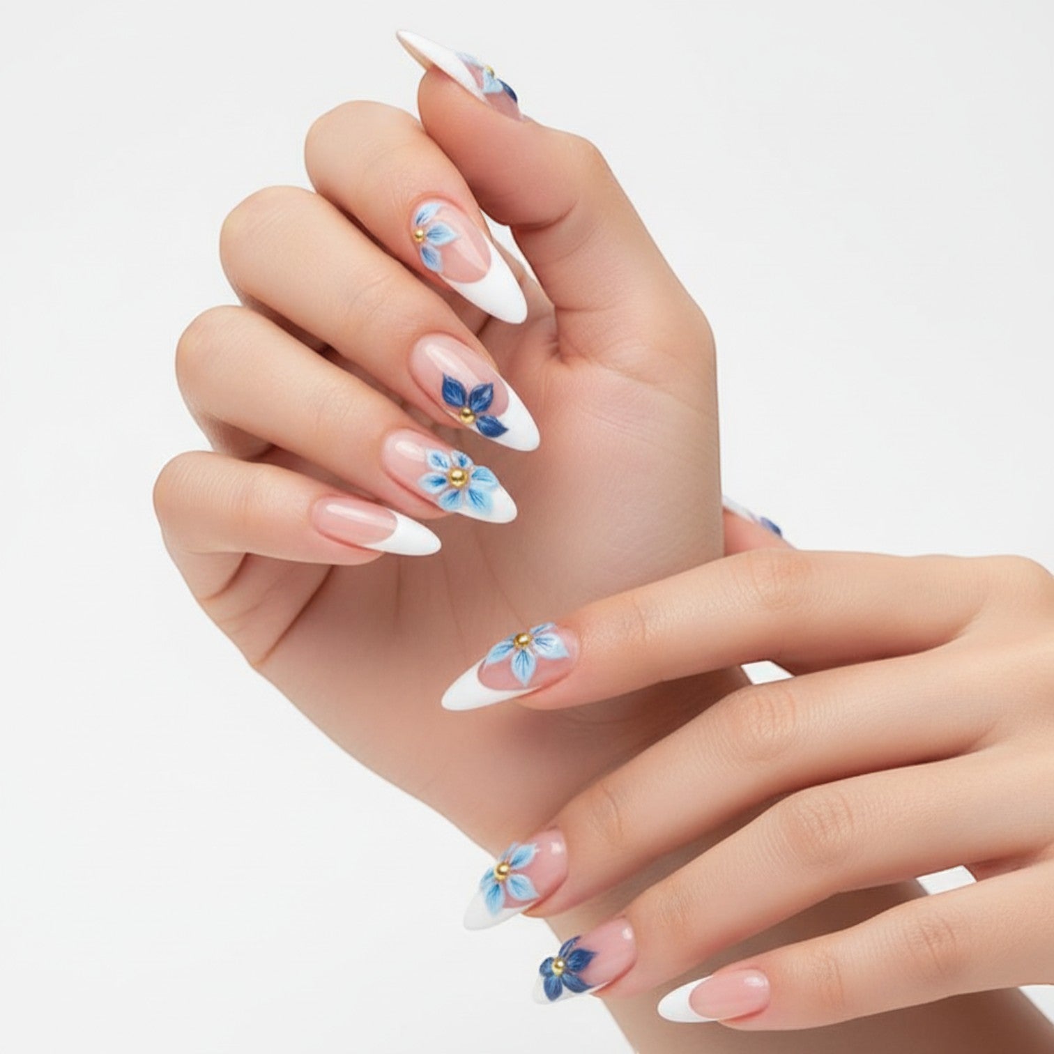 AuraPal French tip press-on nails with blue floral 3D accents and gold beads. Almond shape.