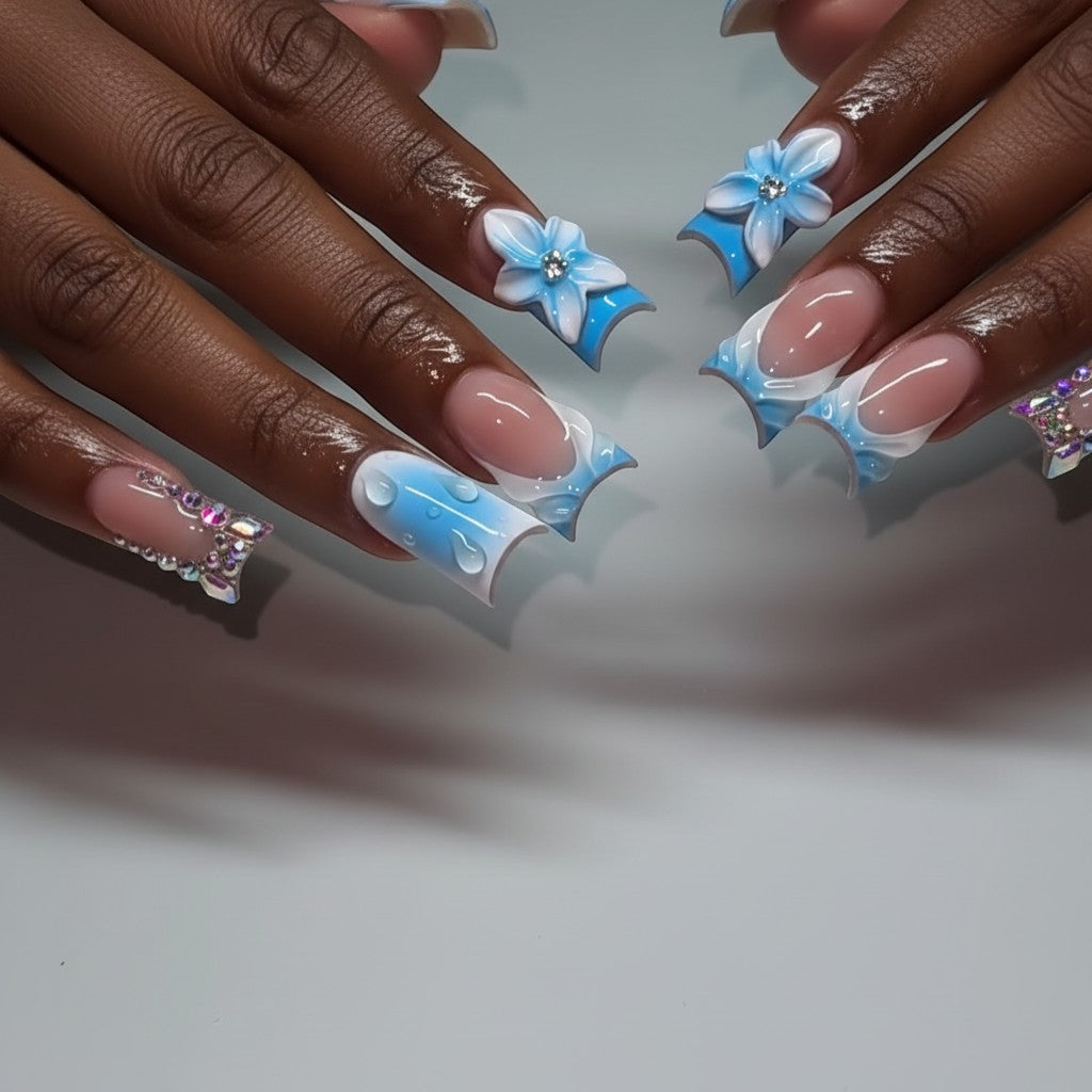Aurapal Press Aura64 blue ombre press-on nails with 3D flowers, water droplets, and rhinestones.