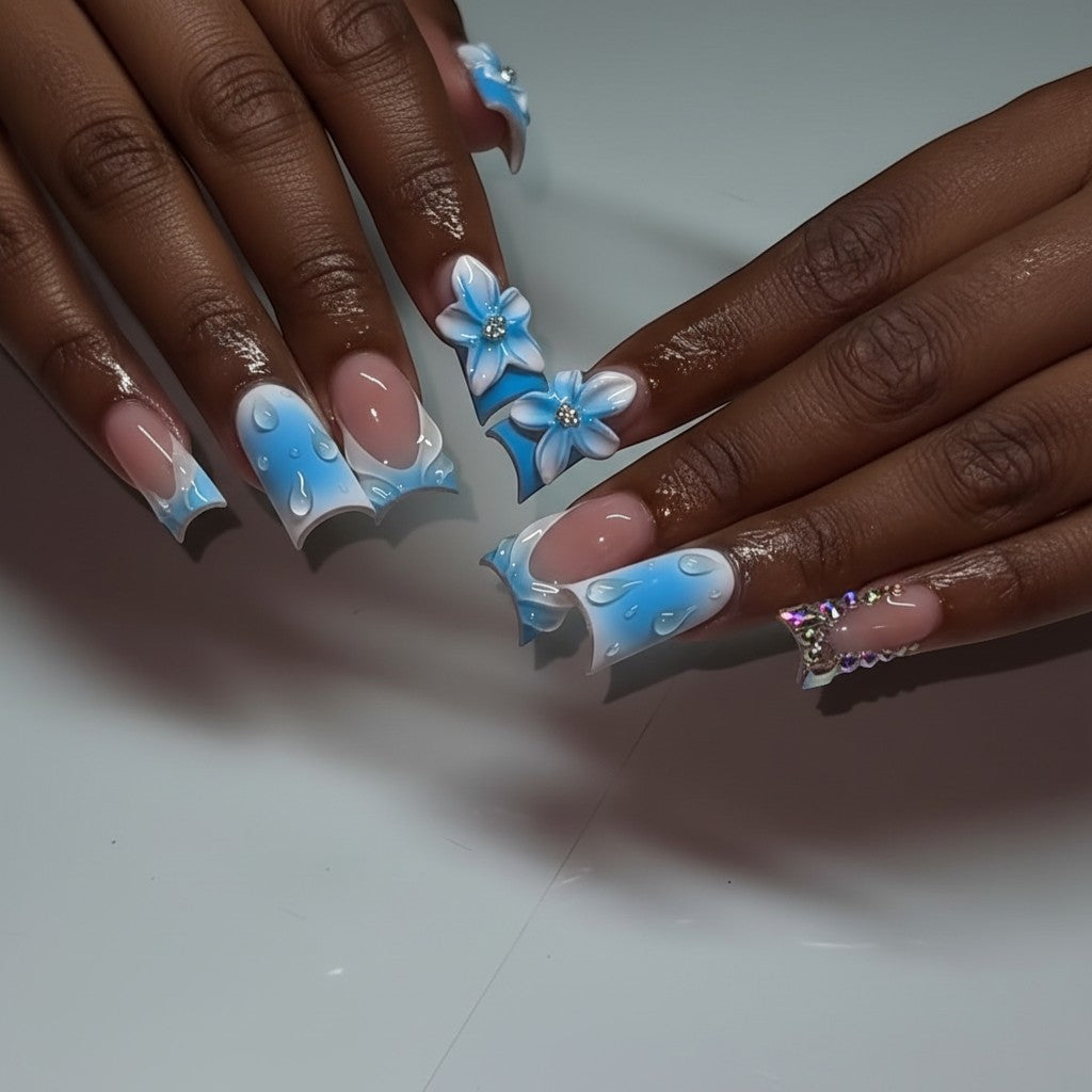 Aurapal Press Aura64 press-on nails with blue ombre, water drops, 3D flowers, and rhinestones.