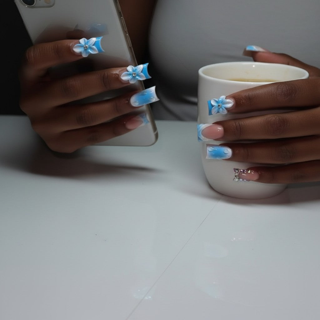 Aurapal blue and white water drop press-on nails with 3D flowers and rhinestones. French tip style.
