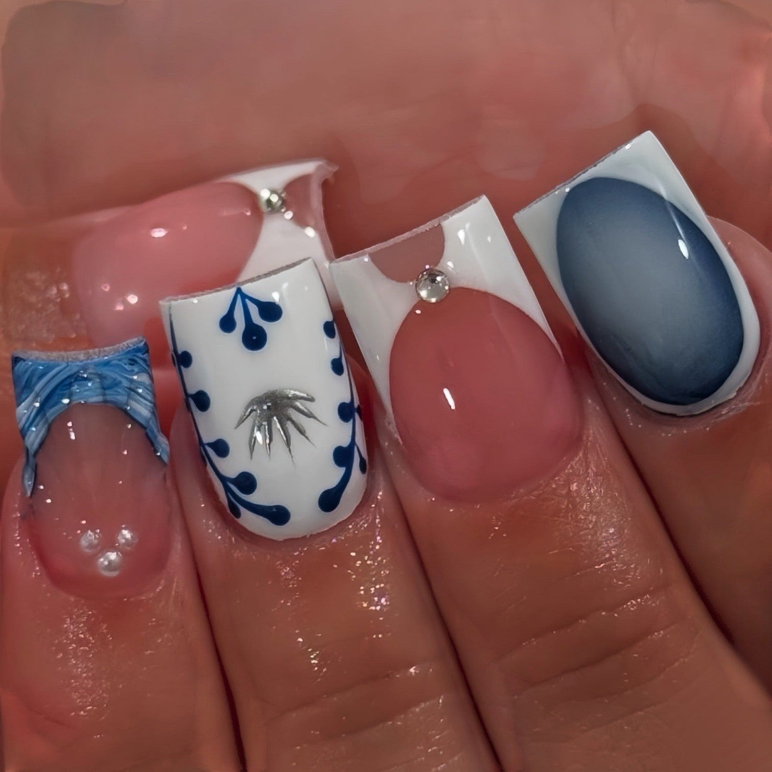 Aurapal press-on nails featuring blue floral patterns, French tips, ombre gradients, and delicate rhinestone accents.