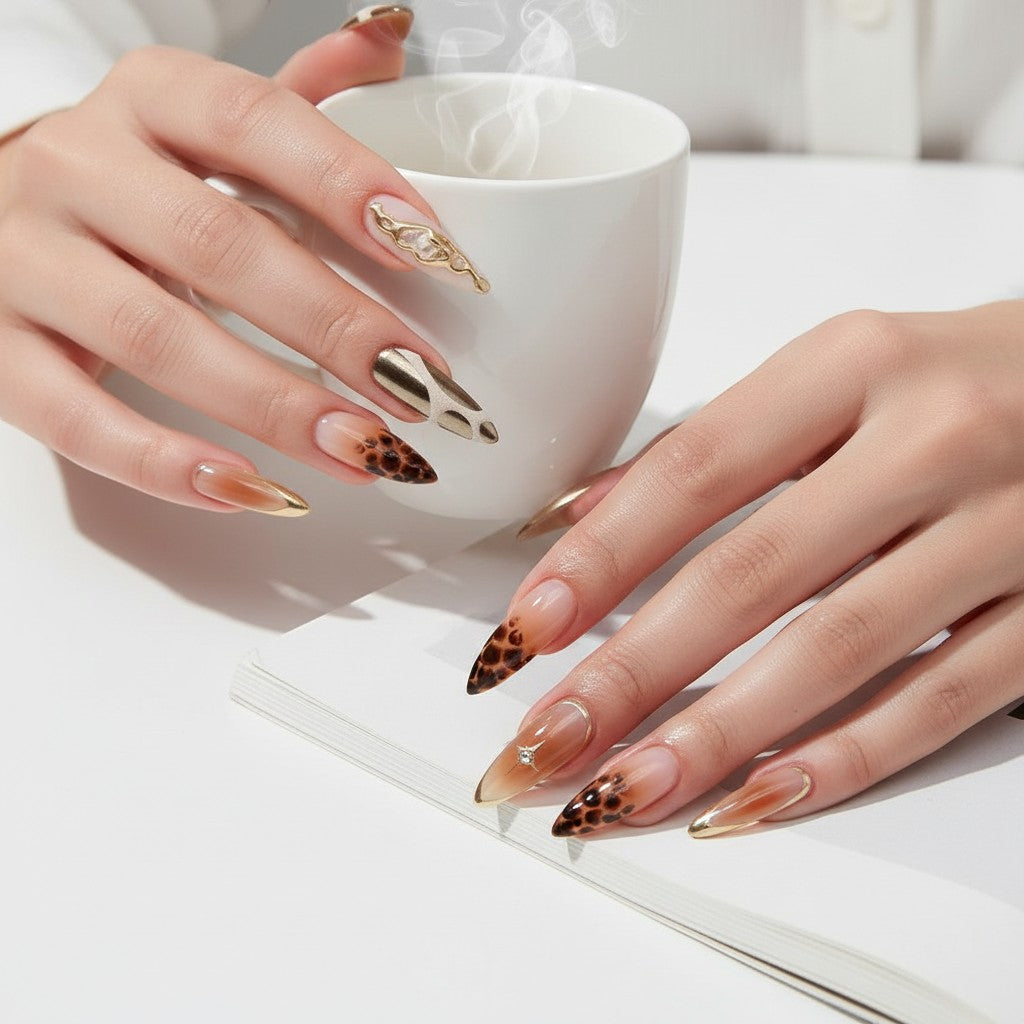 Press Aura47 stiletto press-on nails with leopard print, gold accents, and cow print designs.