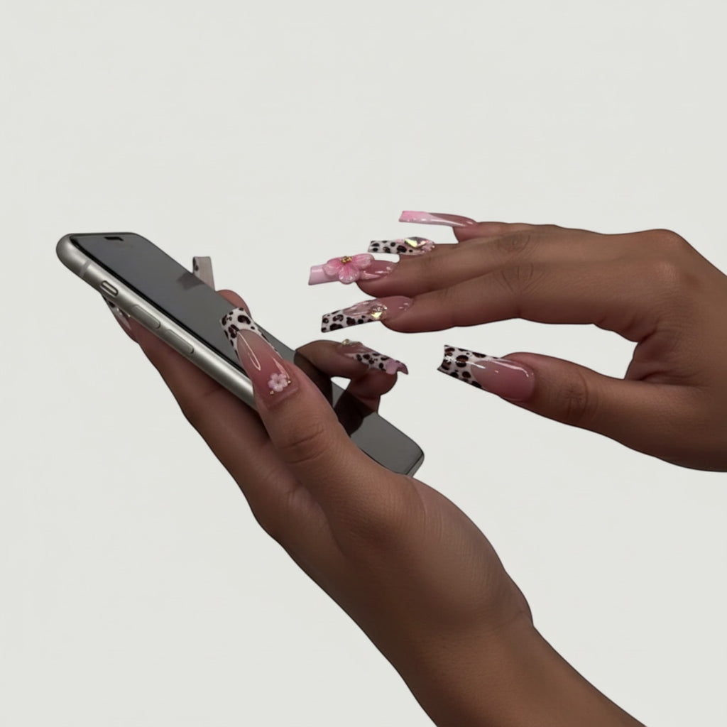 AuraPress54 long coffin press-on nails with pink ombre, leopard print French tips, 3D flowers, and rhinestones.