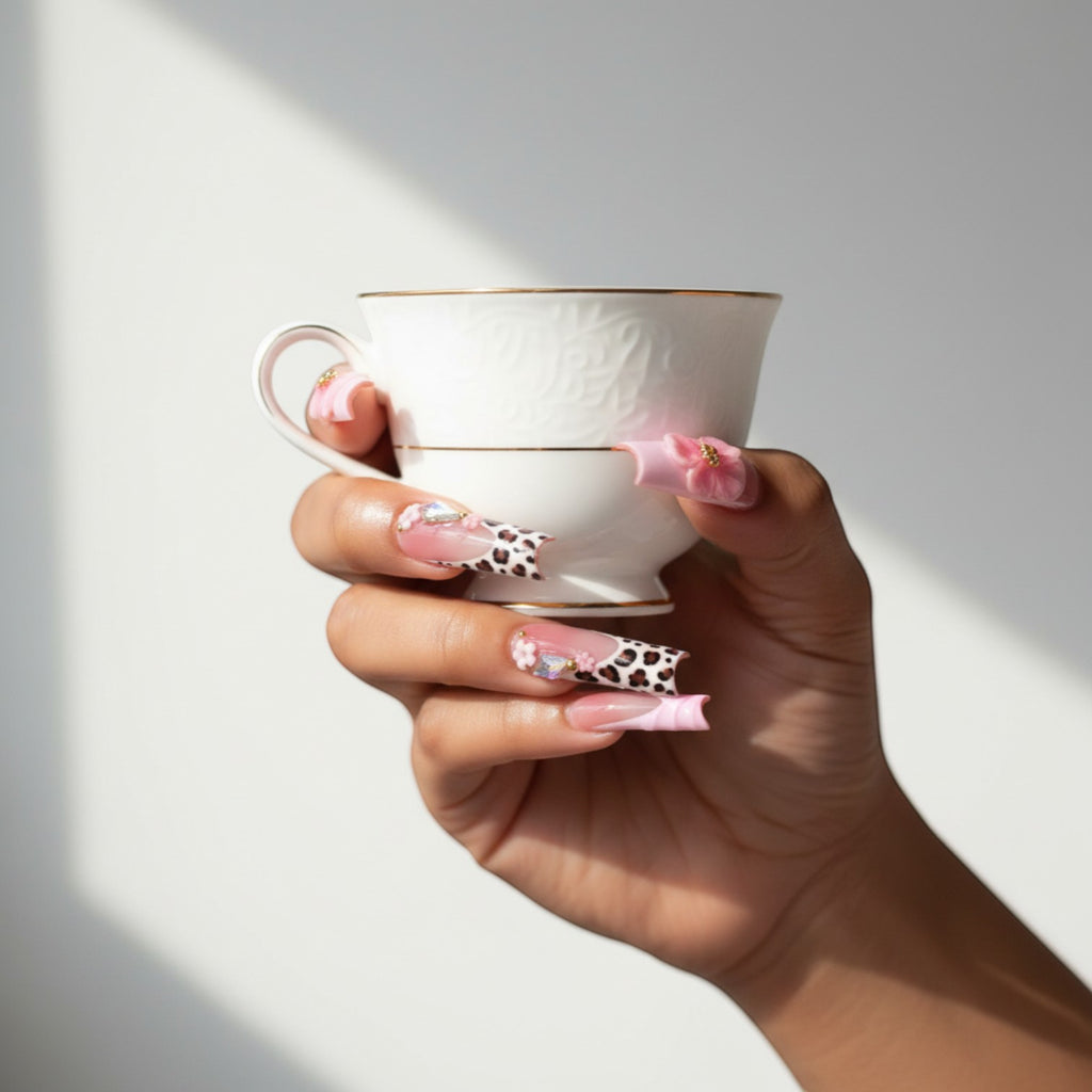 AuraPress54 long coffin press-on nails with pink ombre, leopard print French tips, 3D flowers, and rhinestones.