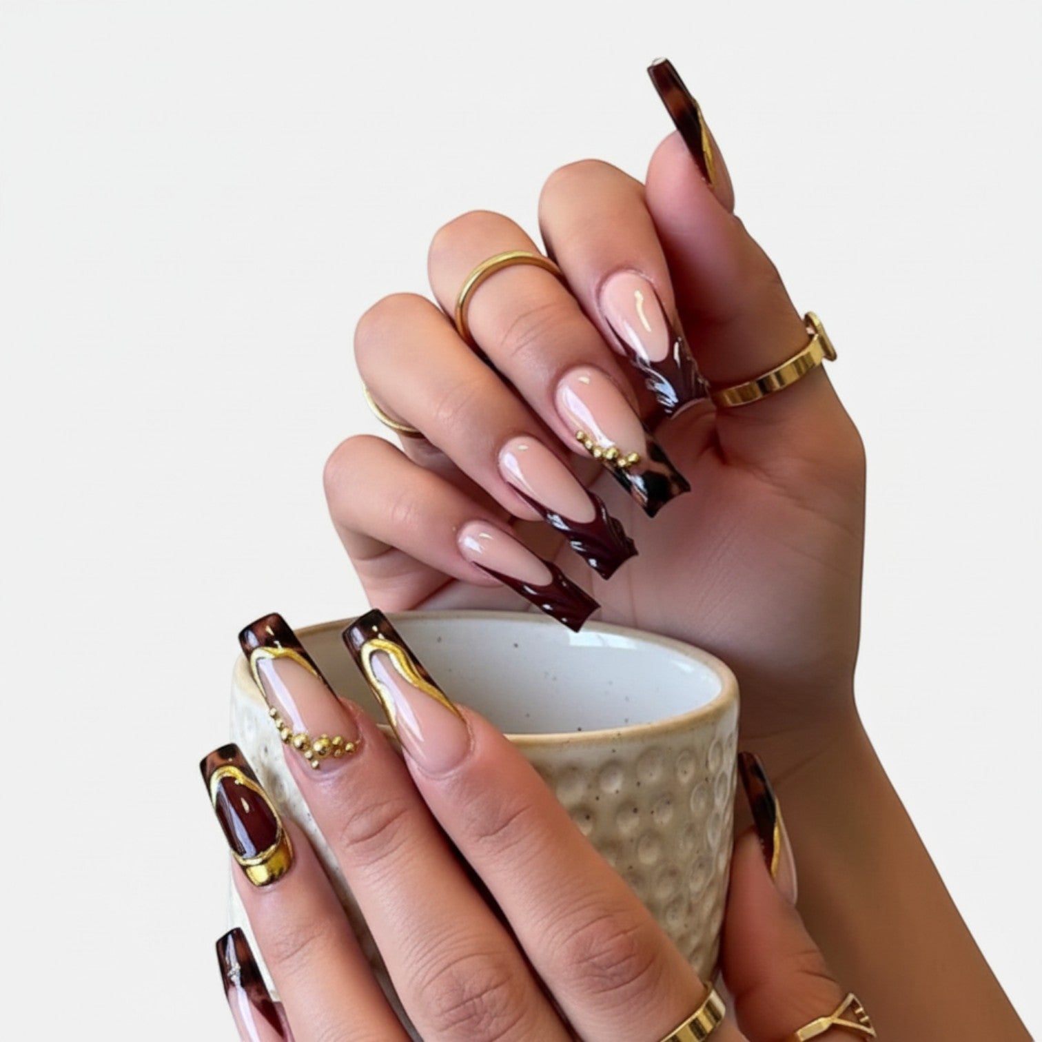 Press Aura57 by AuraPal: long, square-shaped press-on nails with leopard print, gold accents, and deep red French tips.