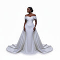 Aurapal off-shoulder white bridal gown with intricate beadwork and a dramatic detachable train on a model