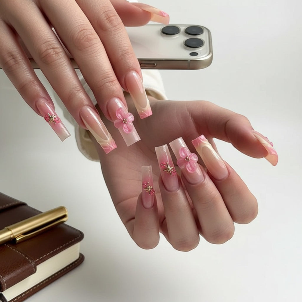 Aurapal Aura49 long square press-on nails with pink French tips and 3D flower embellishments.