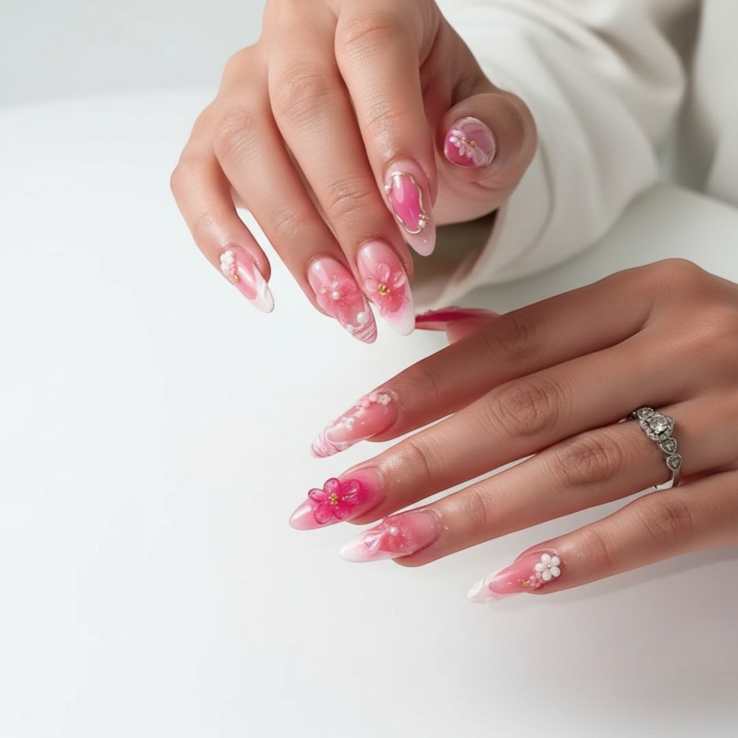 AuraPal Aura34 press-on nails with pink floral 3D accents, pearls, and gold details. Glossy finish.