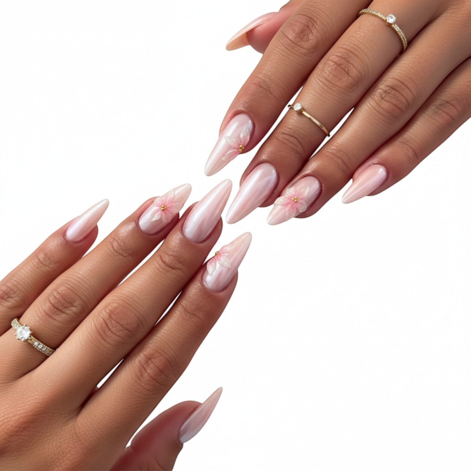 Aura35 press-on nails in pearlescent pink with delicate 3D floral accents and gold bead centers.