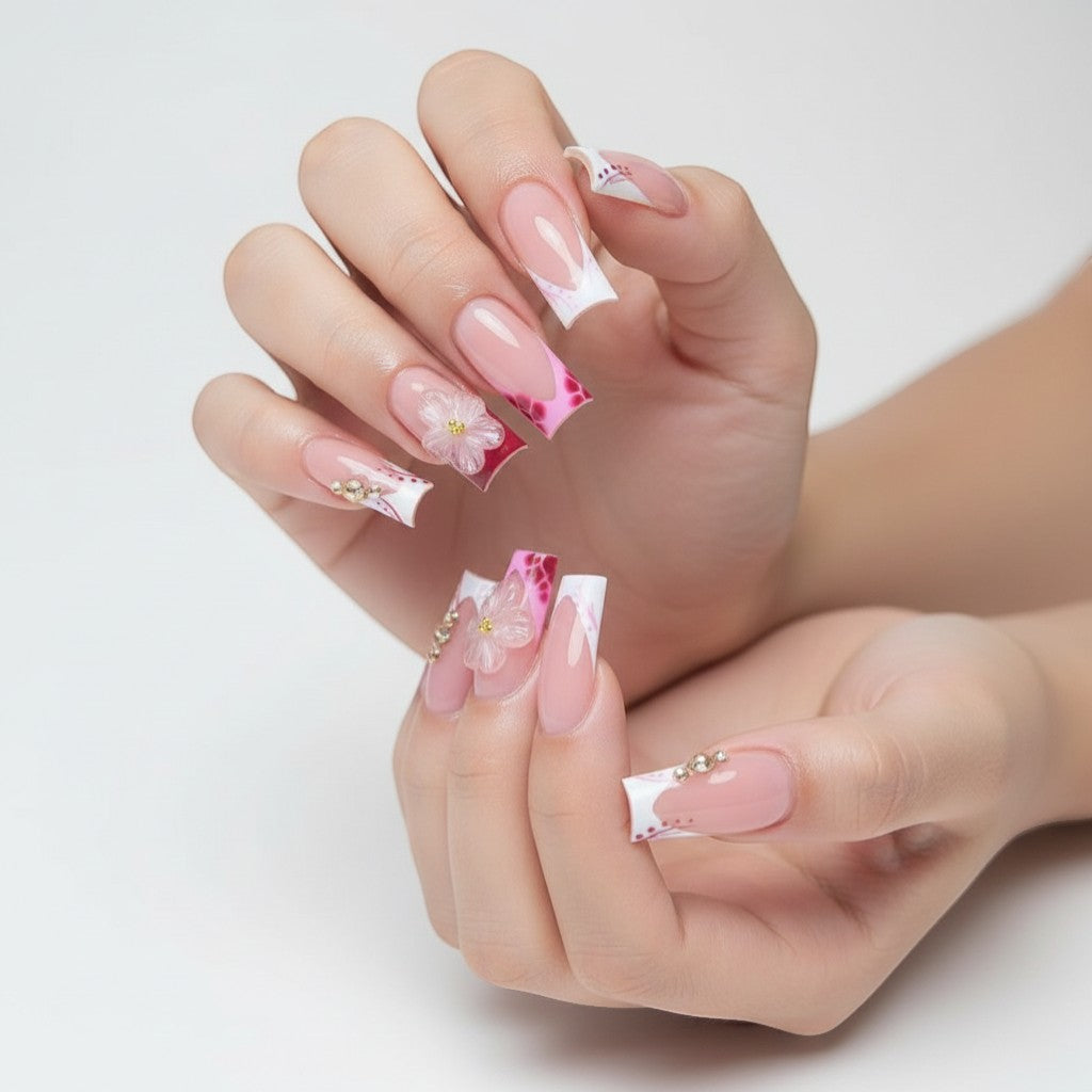 Aurapal Press Aura60 pink French tip press-on nails with floral 3D embellishments and rhinestones.