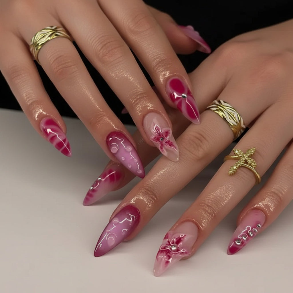 Aurapal Aura40 press-on nails in pink marble and floral designs with rhinestone accents. Stiletto shape.