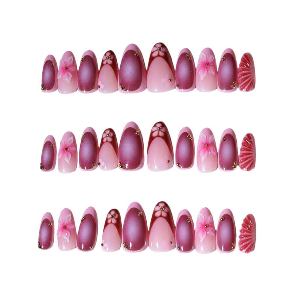 AuraPal press-on nails in pink and mauve with floral designs and gold accents. Almond shape.