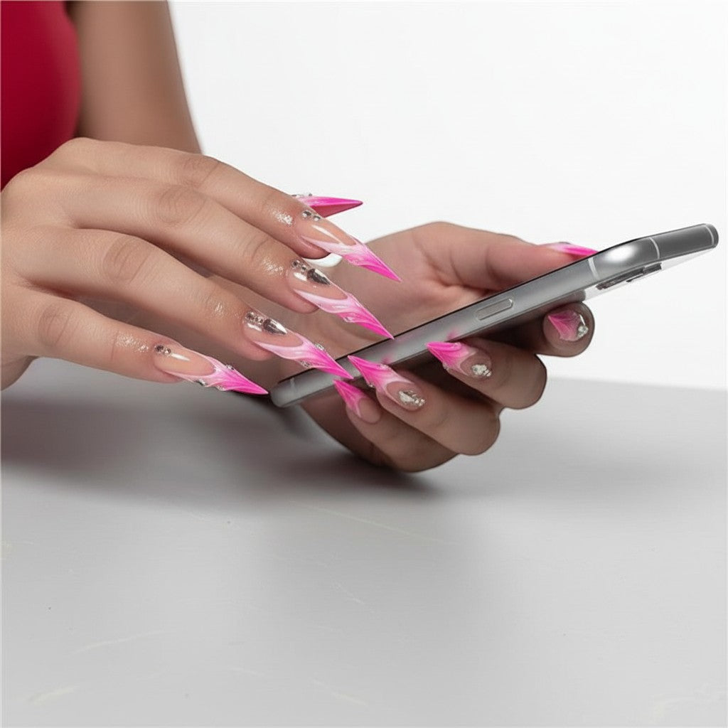 Press Aura16 long stiletto press-on nails with pink and white ombre French tips and rhinestone accents.