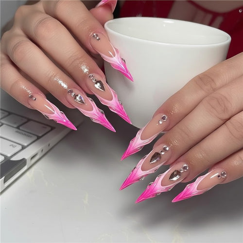 Press Aura16 long stiletto press-on nails with pink and white French tips, adorned with rhinestones and silver charms.