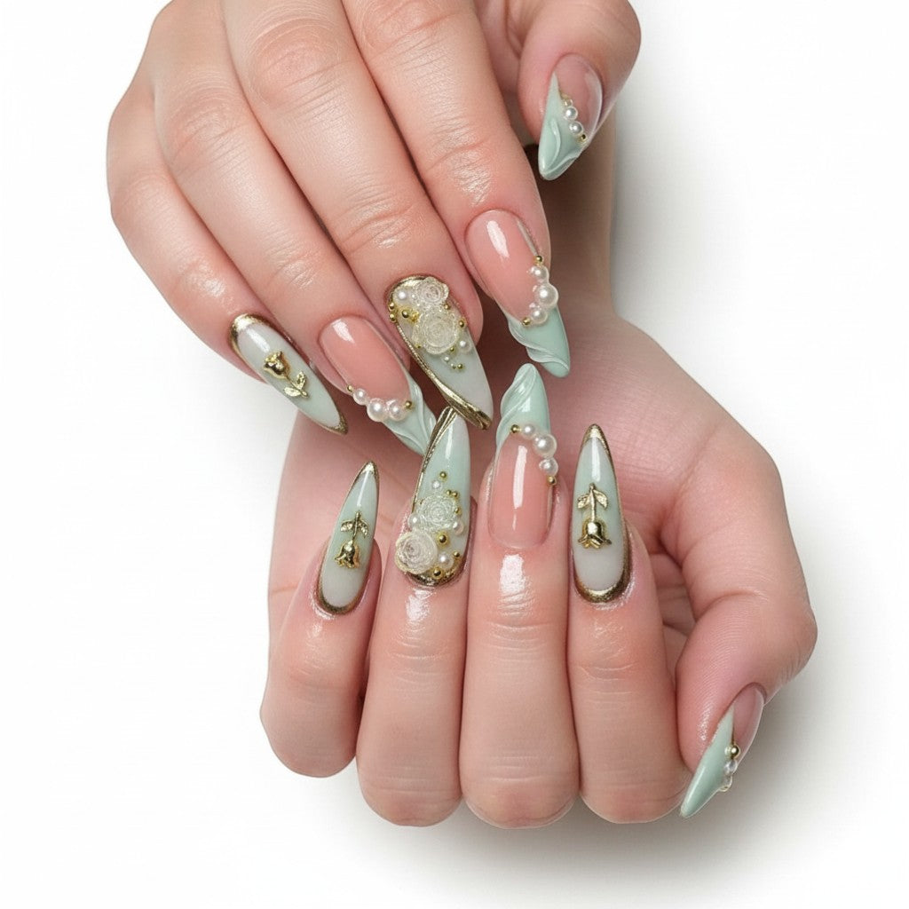 AuraPress Aura19 press-on nails with pink and mint green French tips, adorned with pearls, gold accents, and rose charms.