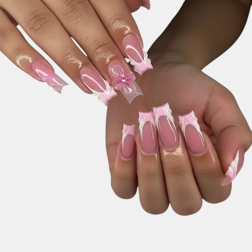 Aura21 press-on nails with pink French tips, 3D floral accents, and a glossy finish.