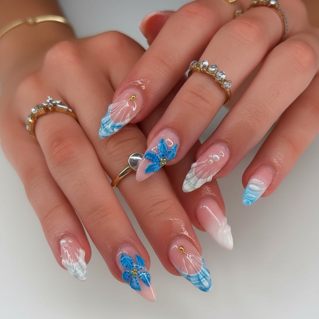 AuraPress Aura24 press-on nails with blue floral and plaid designs, clear finish, and gold accents.