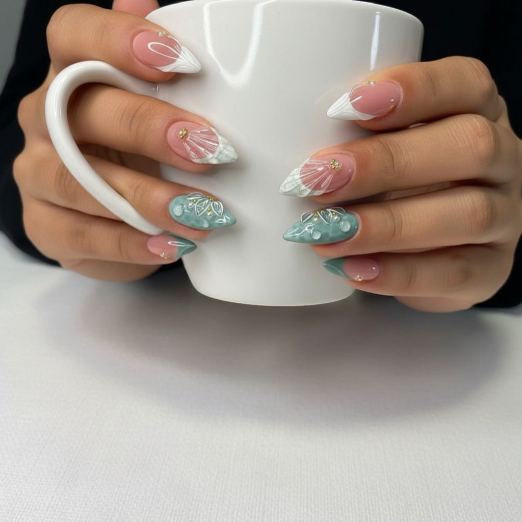 AuraPress Aura37 press-on nails in almond shape, featuring a mix of pink and teal with 3D floral, water drop, and shell designs, accented with pearls and gold studs.