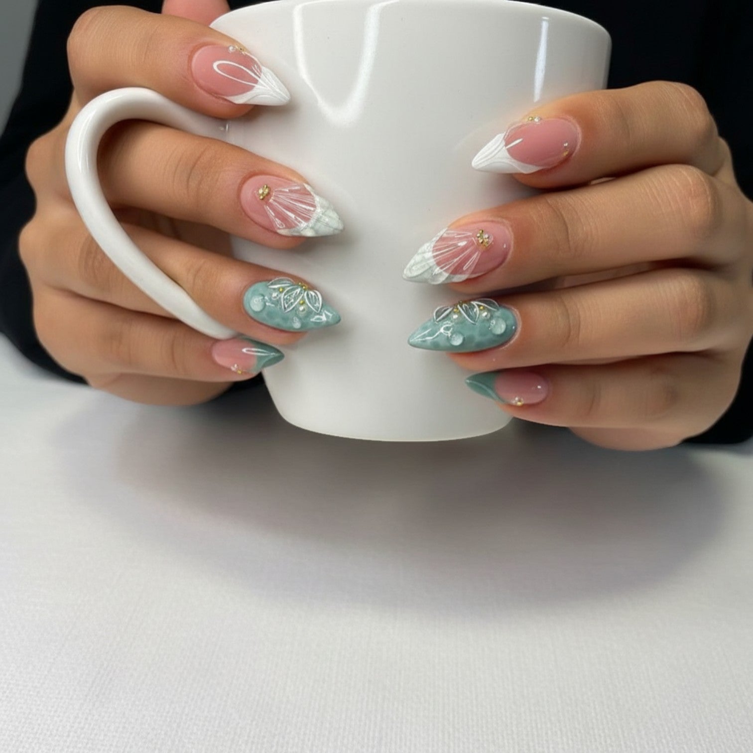 AuraPress Aura37 press-on nails in almond shape, featuring a mix of pink and teal with 3D floral, water drop, and shell designs, accented with pearls and gold studs.