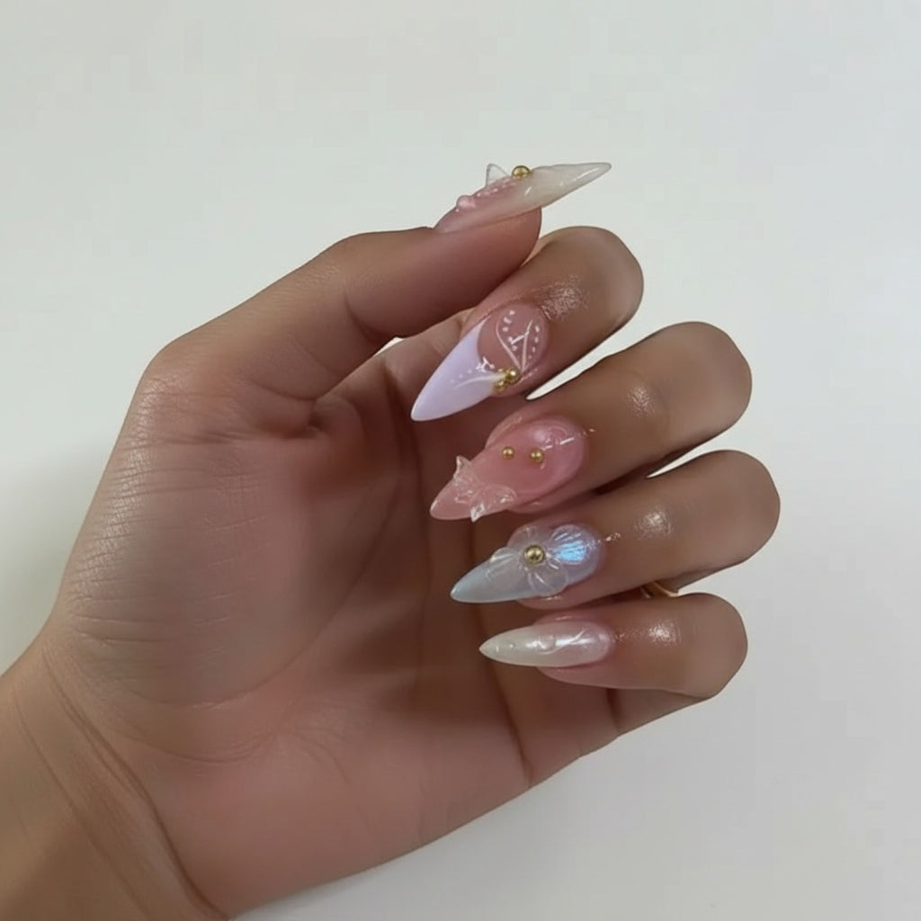 Press Aura42 by AuraPal: whimsical press-on nails with 3D flowers, pearls, and butterfly accents in pastel blue, pink, and iridescent finishes.