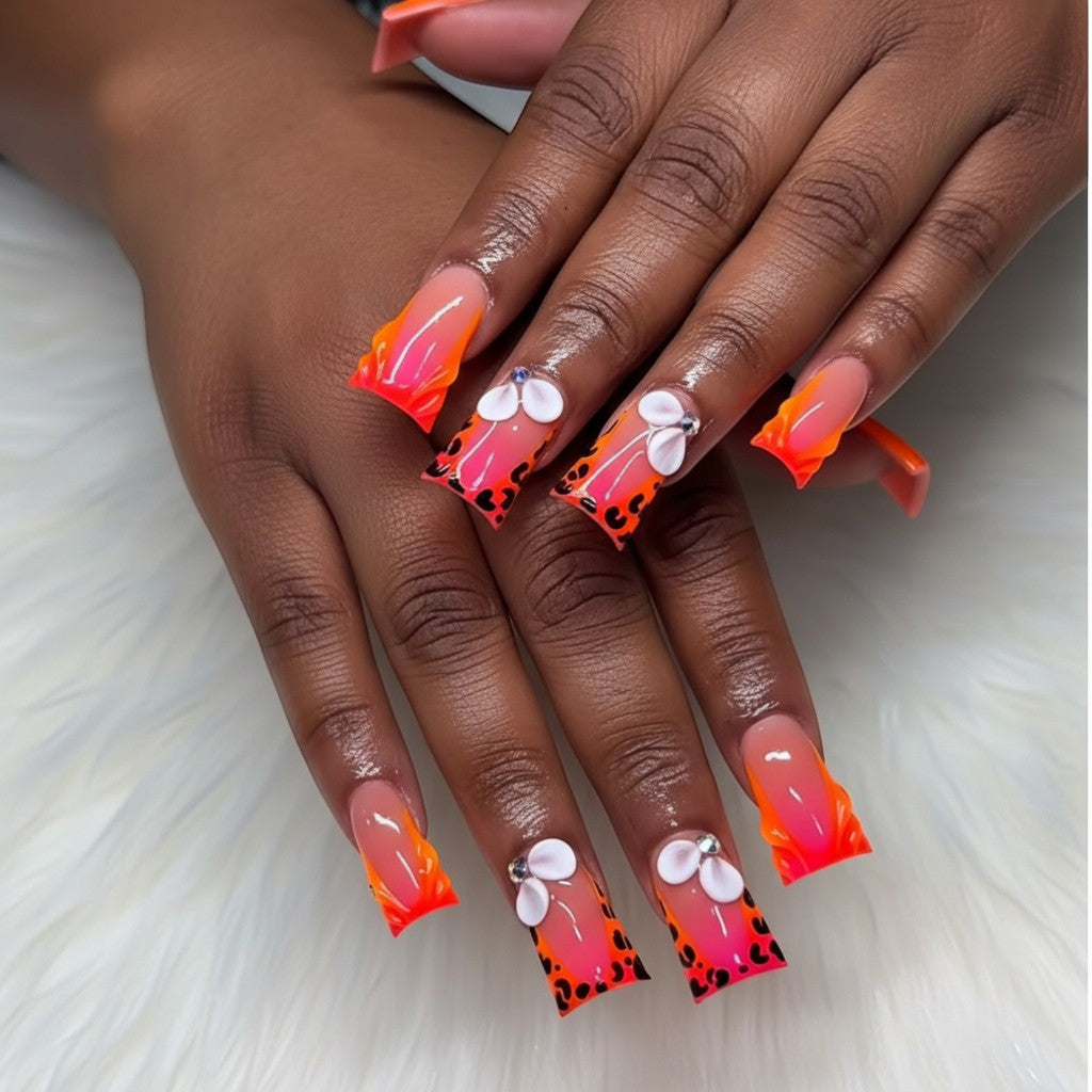 AuraPal Press Aura63 press-on nails with neon orange French tips, leopard print, and 3D floral accents.