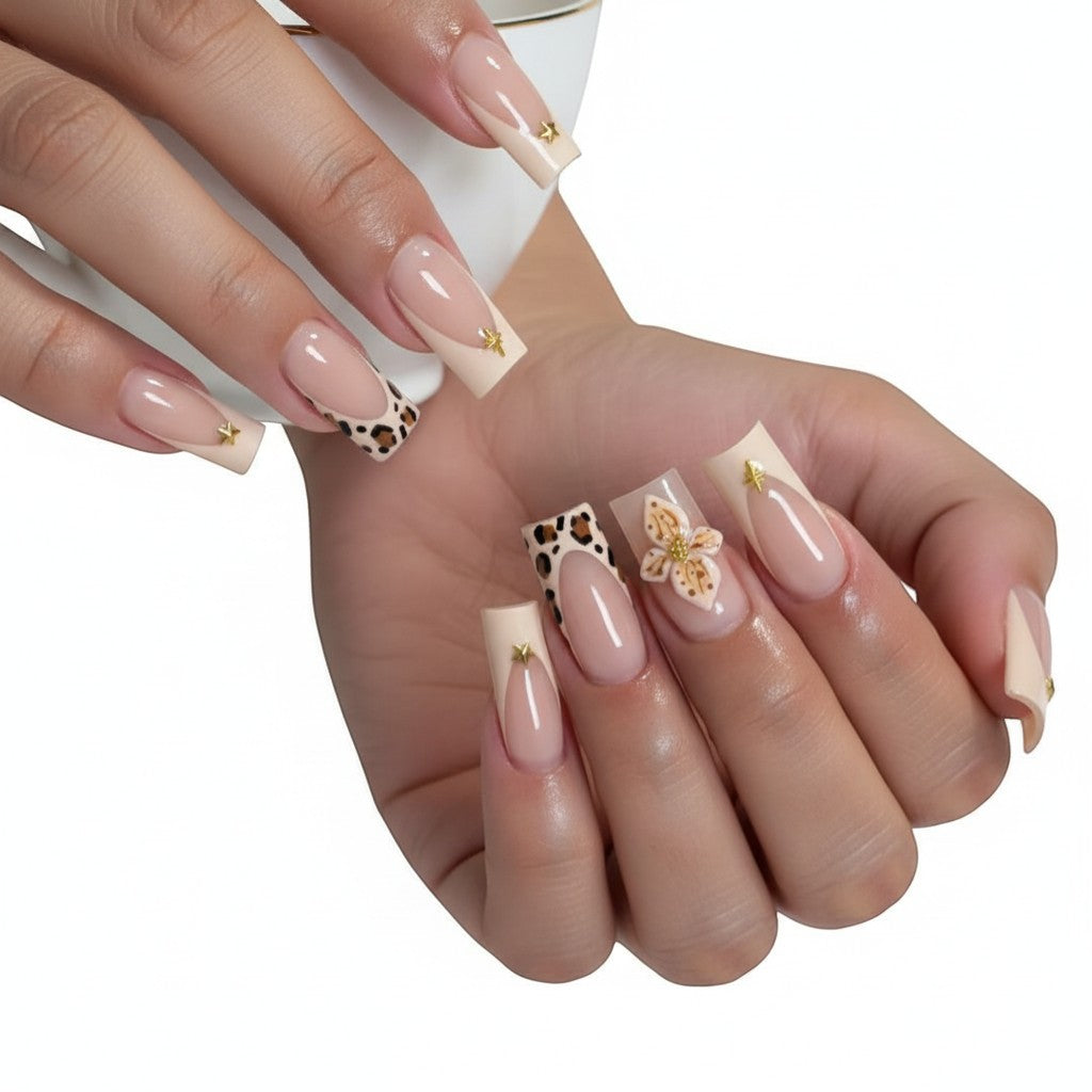 Aura8 press-on nails with French tips, leopard print, and a 3D floral accent. Gold star embellishments.