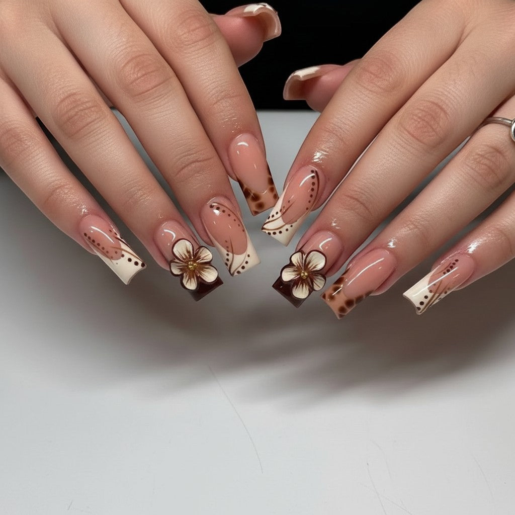 Press Aura9 brown and cream French tip press-on nails with 3D floral accents and dot details.