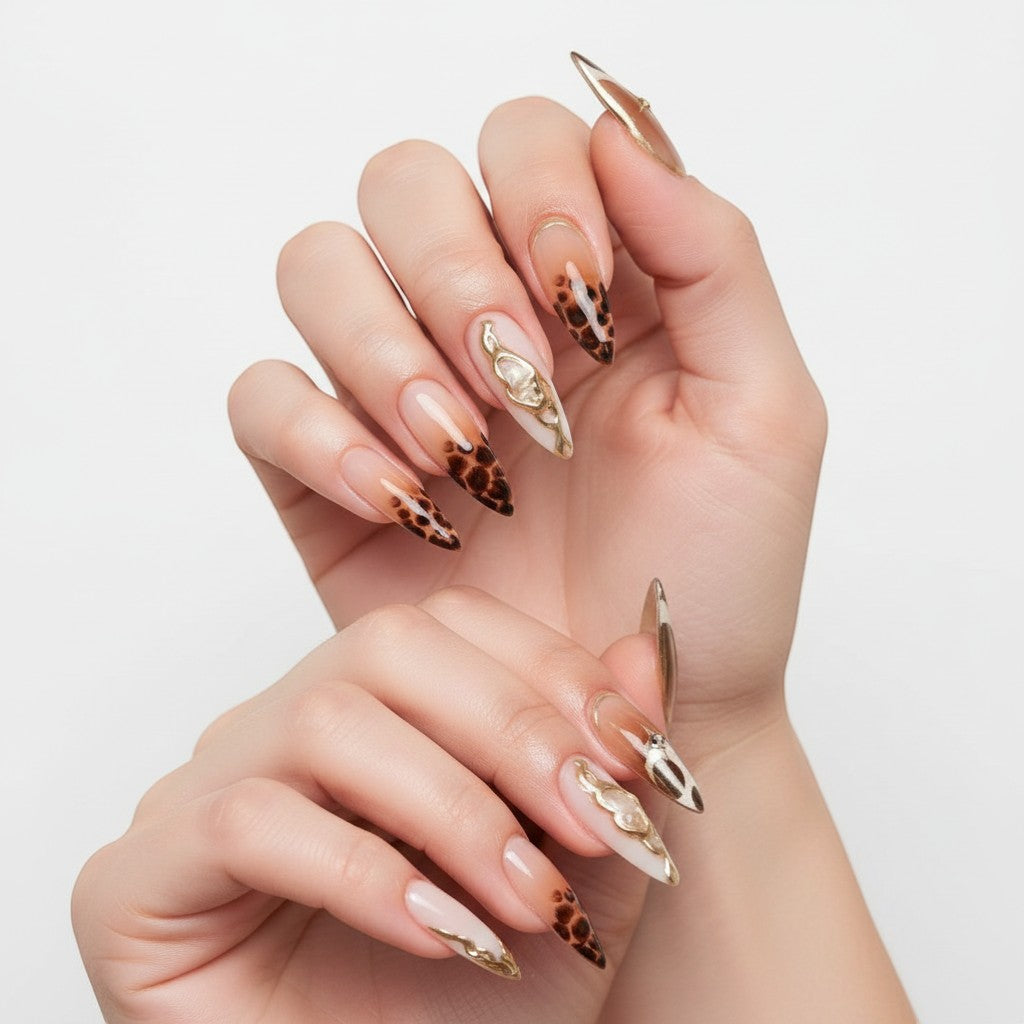 Aura47 press-on nails with leopard print, cow print, gold accents, and rhinestones. Almond shape.
