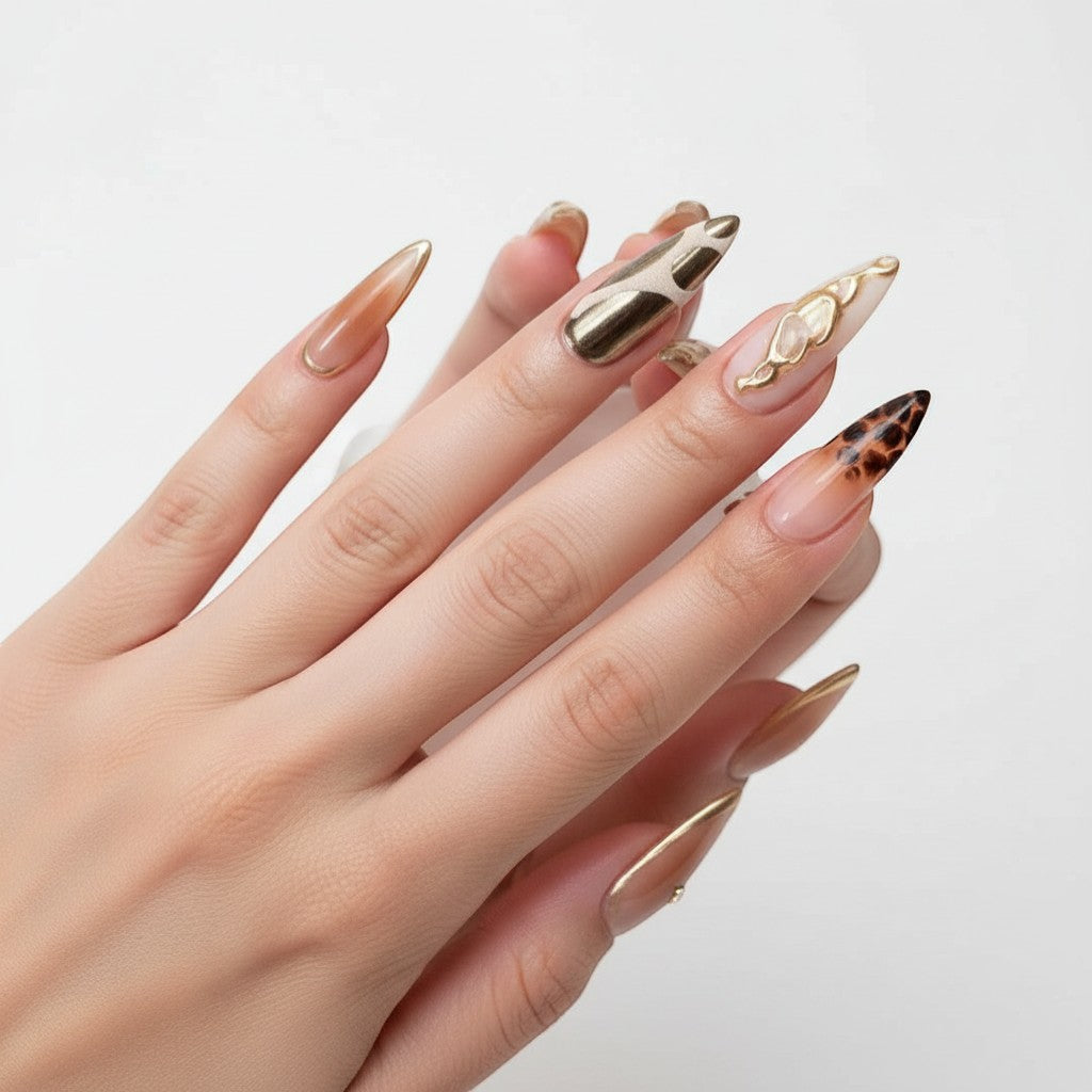 Aura47 press-on nails with leopard print, cow print, gold accents, and rhinestones.
