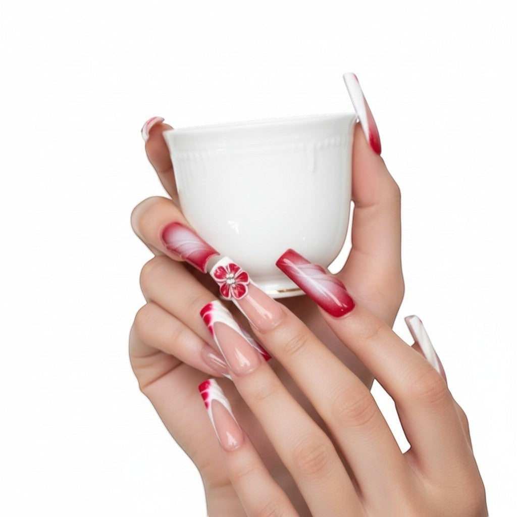 Aura14 press-on nails: red and white French tips with 3D red flowers and swirl designs.