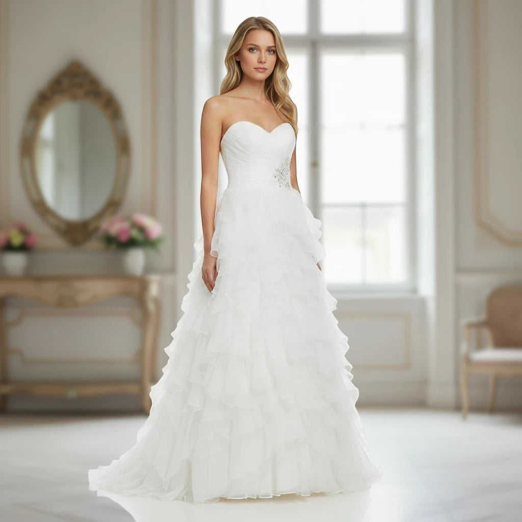 Aurapal strapless white tulle wedding gown with a sweetheart neckline, ruched bodice, and cascading ruffled skirt.
