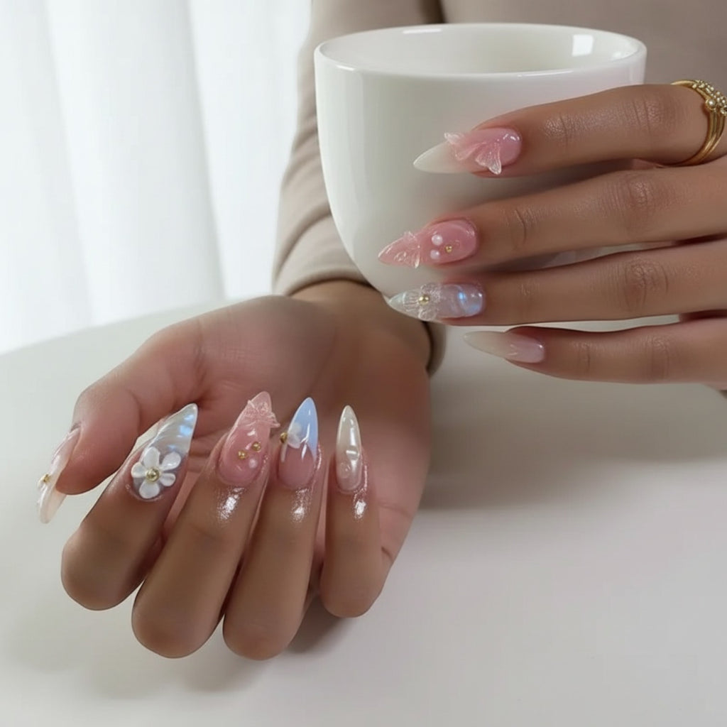 Press Aura42 by AuraPal: whimsical press-on nails with 3D flowers, pearls, and butterfly accents in pastel pink, blue, and iridescent finishes.