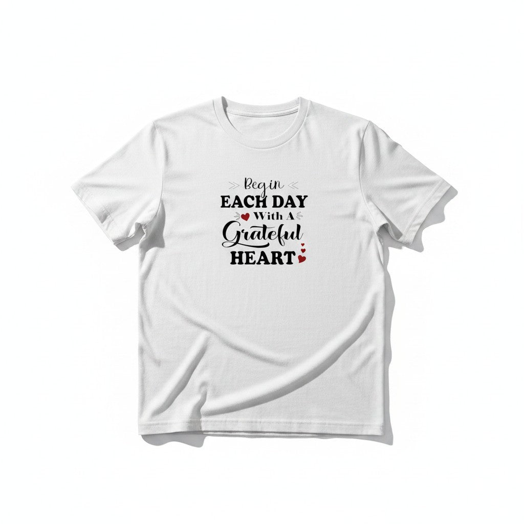 Aurapal white crewneck t-shirt featuring black typography and red heart accents with the text Begin Each Day With A Grateful Heart.